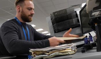 Male NHSBSA employee working on scanner